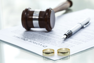 divorce decree with gavel and rings