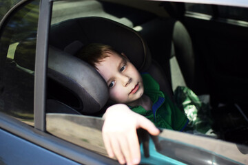 child in backseat of car