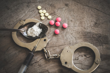 handcuffs and drugs on table