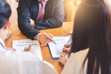 lawyer and couple signing separation agreement