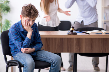 child looking sad while parents fight in background