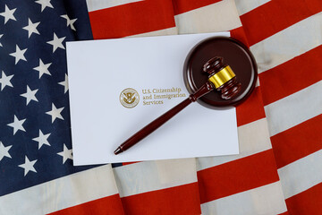 gavel and USCIS paper on american flag; Montgomery County Citizenship Lawyer concept image