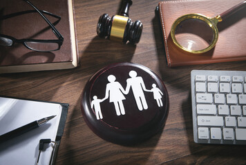 gavel on desk with paper cut out of family