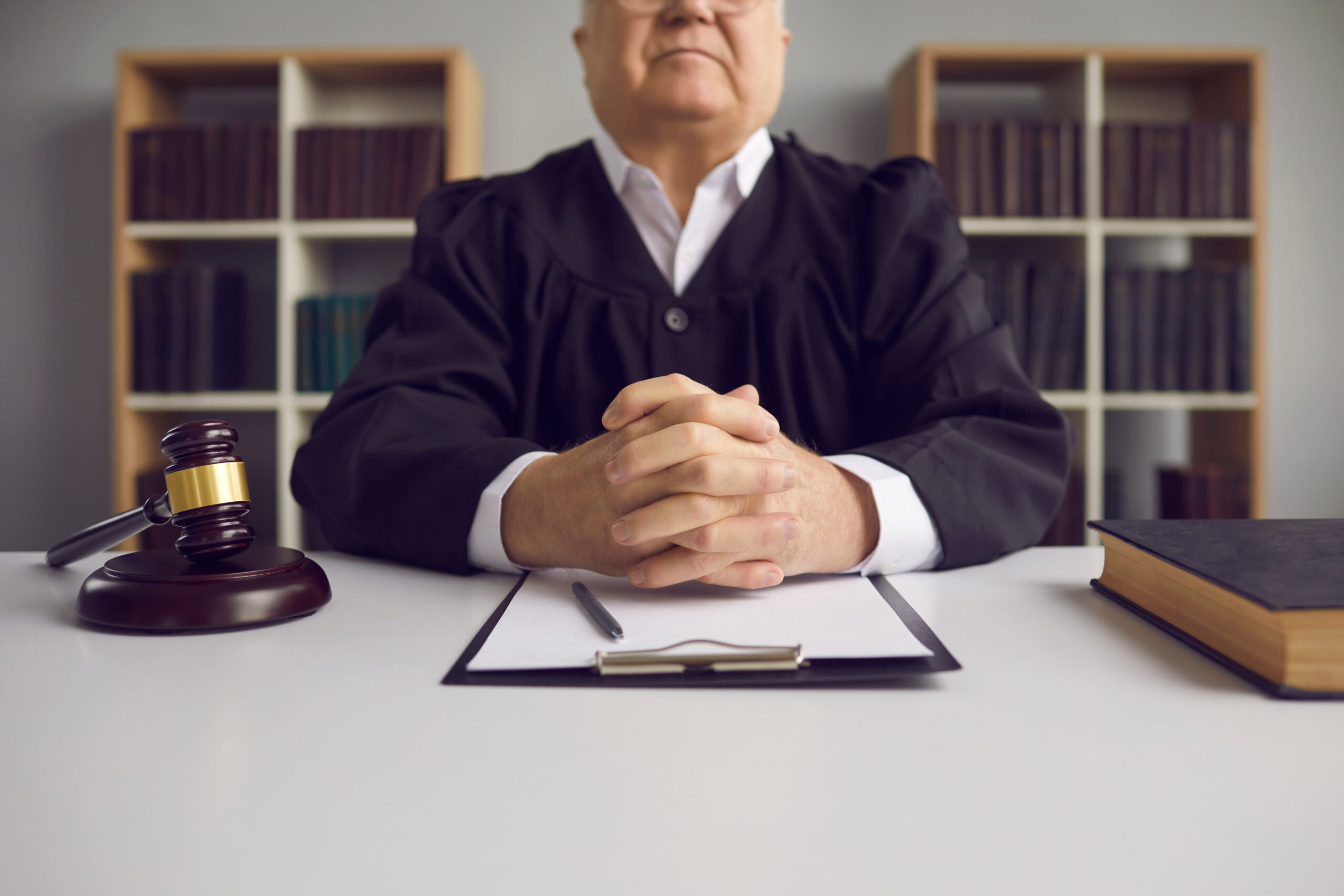 fair incorruptible old male judge at table with gavel and case papers in courtroom considering Accelerated Rehabilitative Disposition for a defendant; Montgomery County ARD Lawyer concept image
