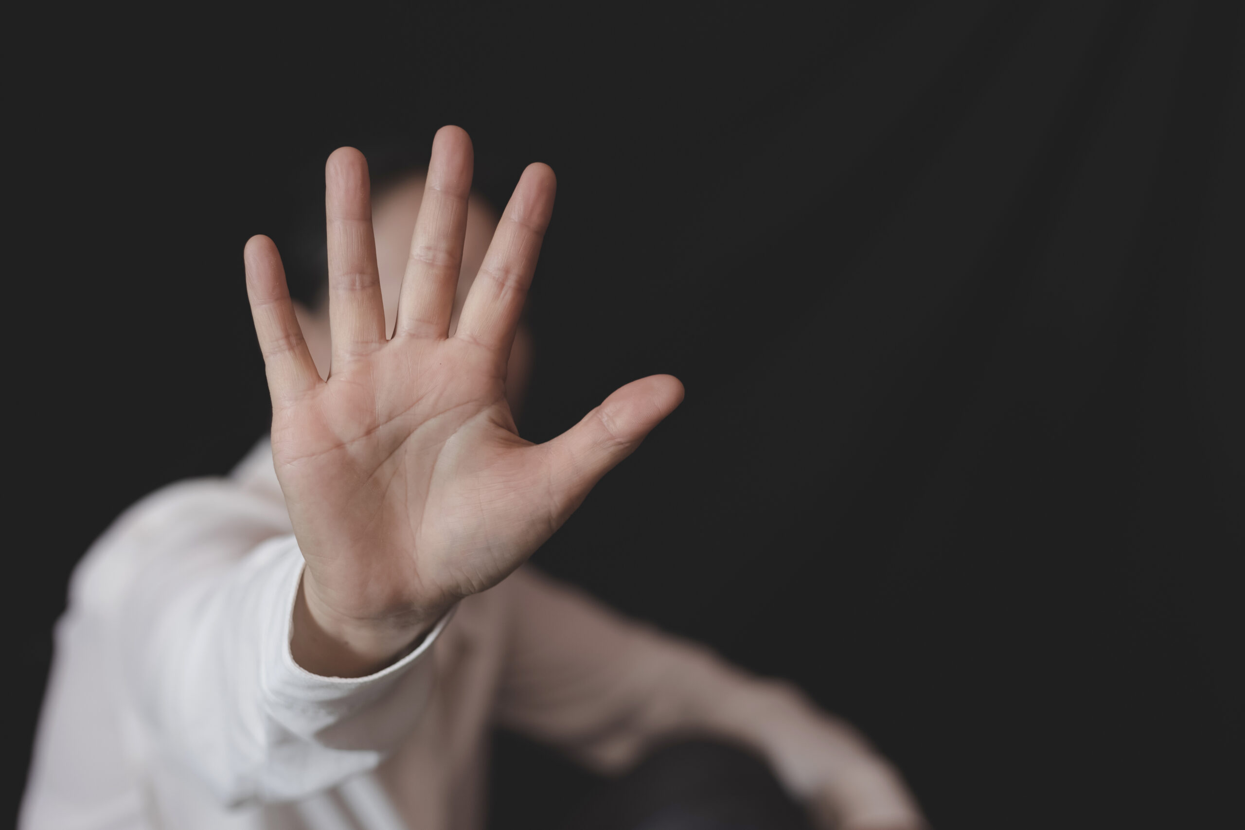 person with hand out harassed